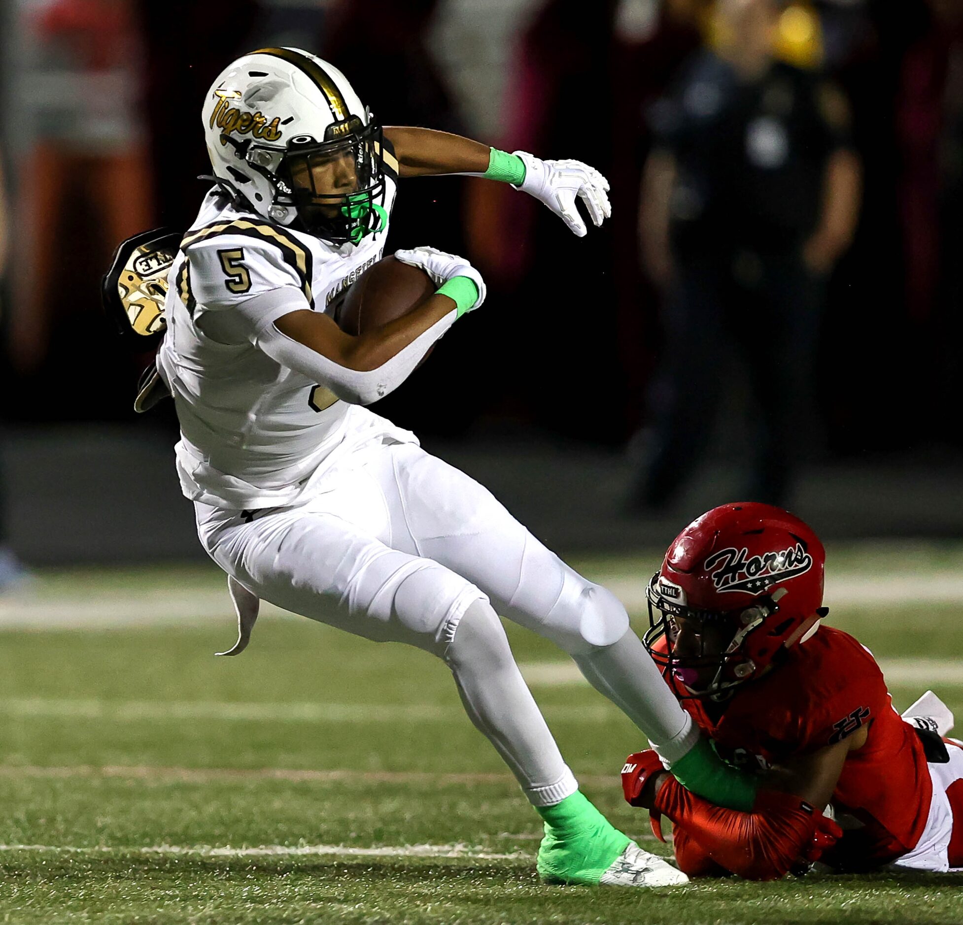 Mansfield running back Marquise Hubbard (5) tries to break a tackle from Cedar Hill...