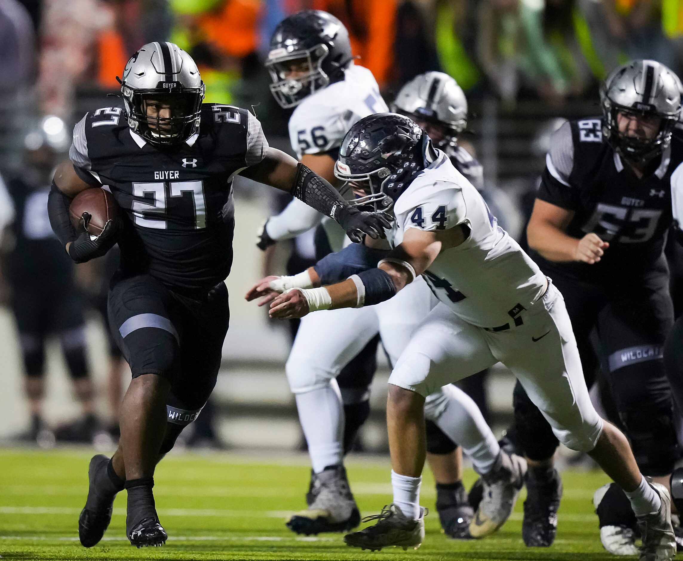 Denton Guyer running back Byron Phillips (27) gets past Flower Mound linebacker Ryan...