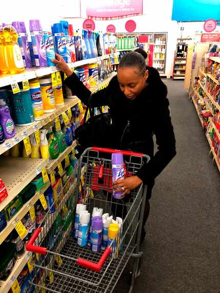 Detroit middle school principal Deborah Charaman stocks up on Lysol disinfectant spray...