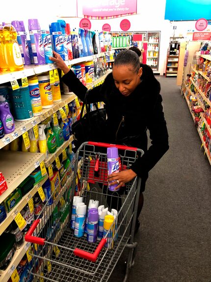 Detroit middle school principal Deborah Charaman stocks up on Lysol disinfectant spray...