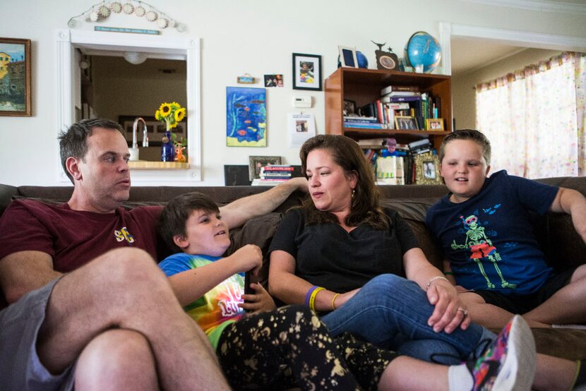 Andrew Morrison, Marilyn, 9, Chelsa and Miles, 10, lounge on the couch in their Grapevine...