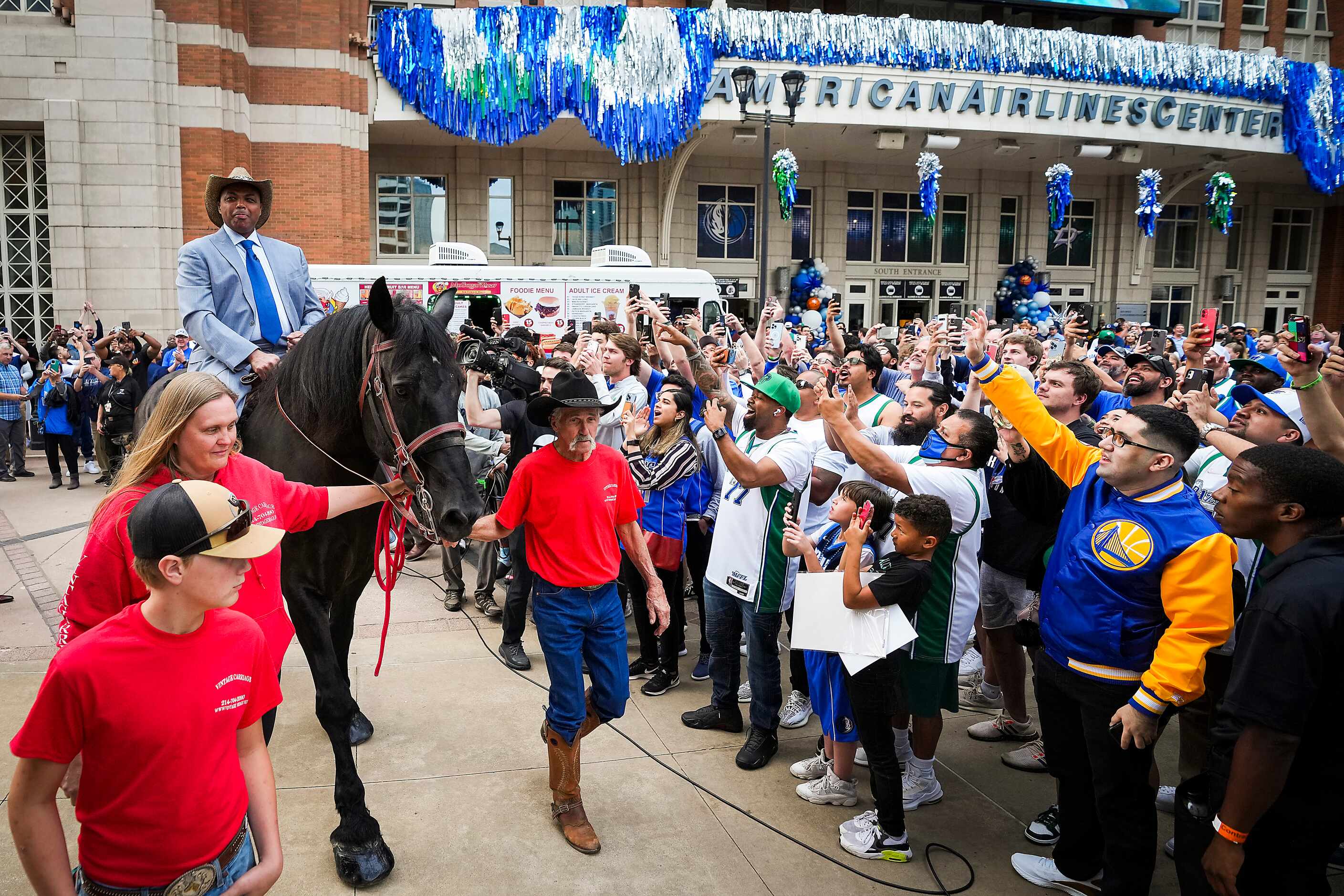 Charles Barkley arrives on horseback at the American Airlines Center as he makes his way to...