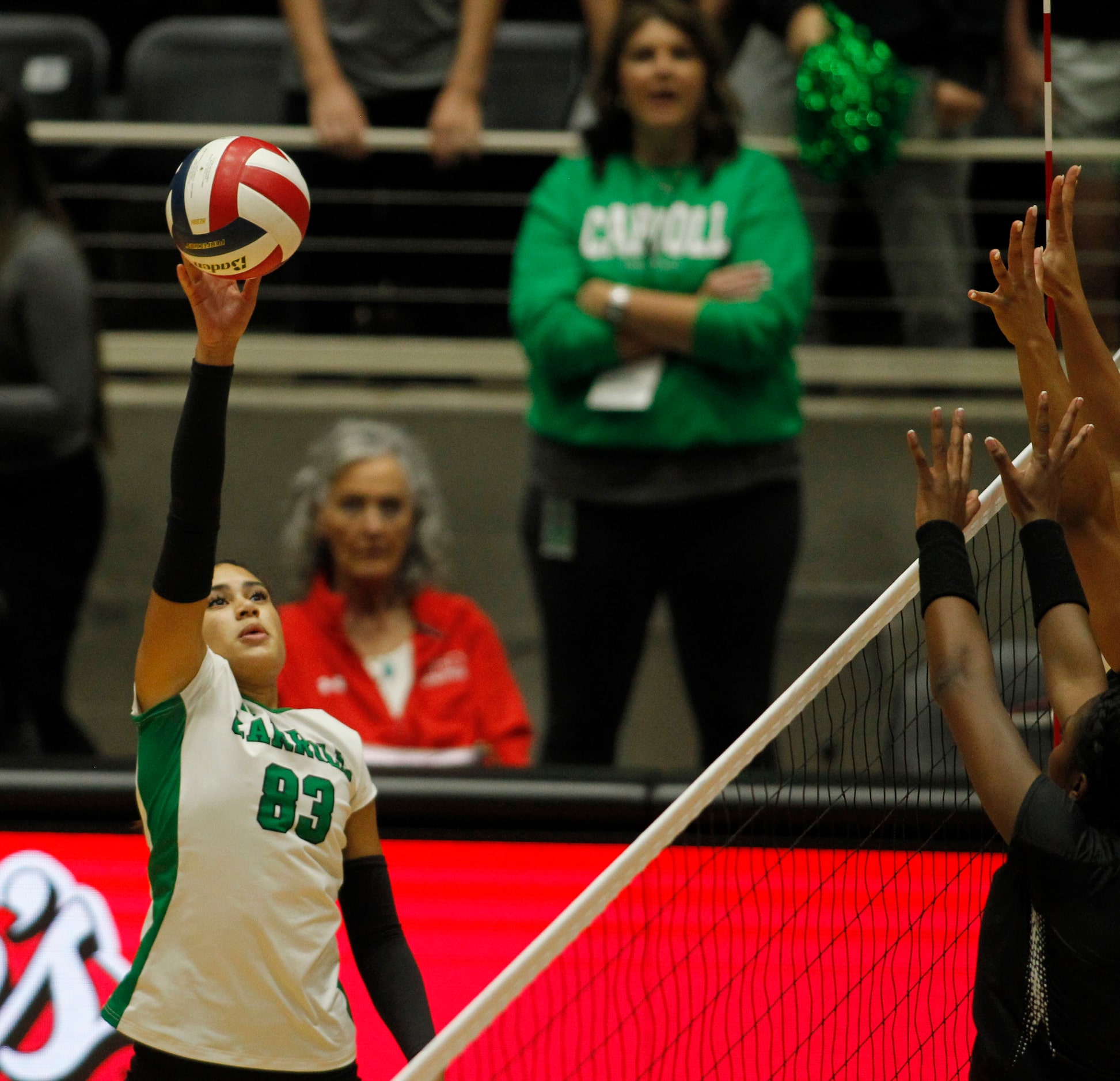 Southlake Carroll outside hitter Vanessa Glenn (83) returns a volley during the first set of...