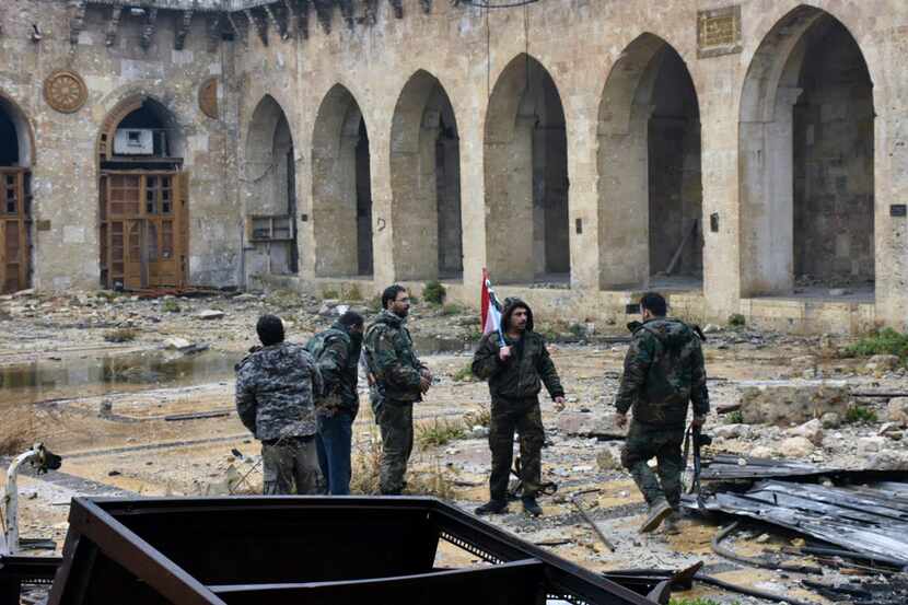This photo released by the Syrian official news agency SANA, shows Syrian troops and...