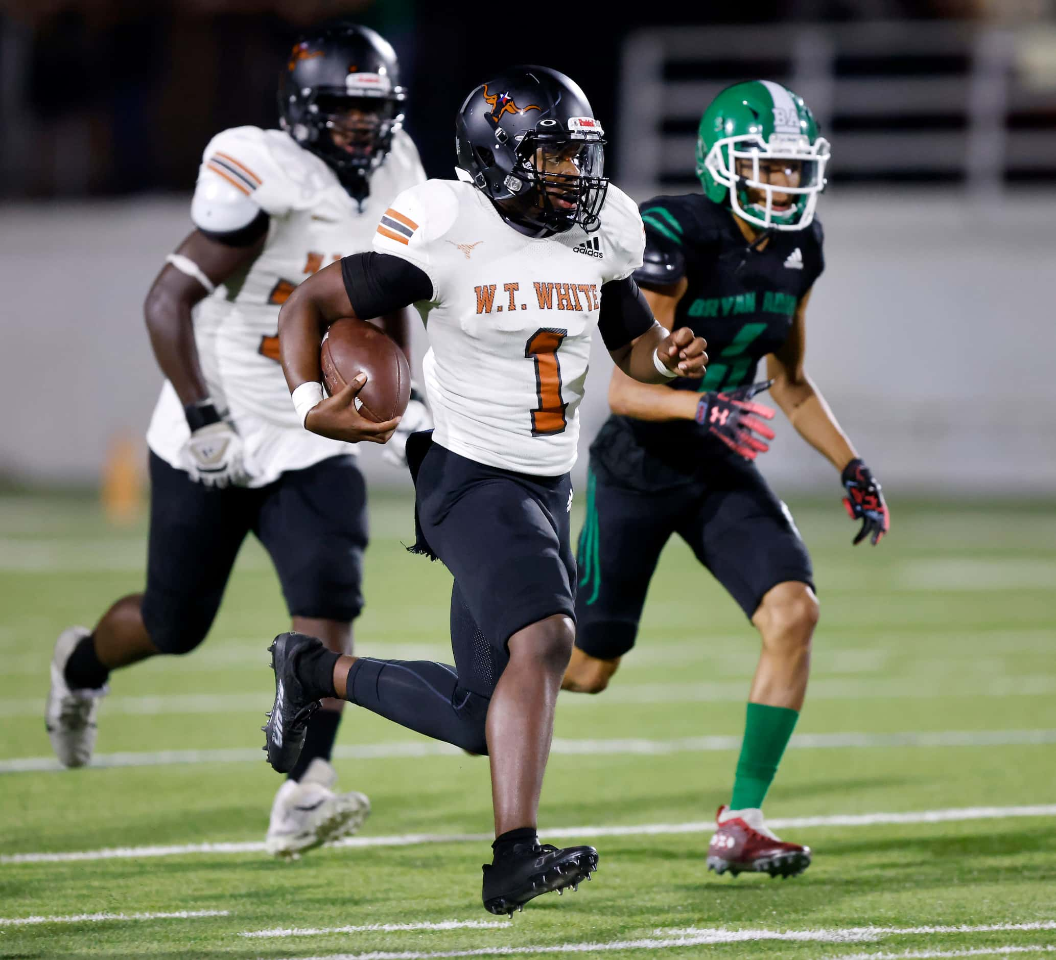 W.T. White quarterback Jaydyn Sisk (1) carries the ball against Bryan Adams during the...