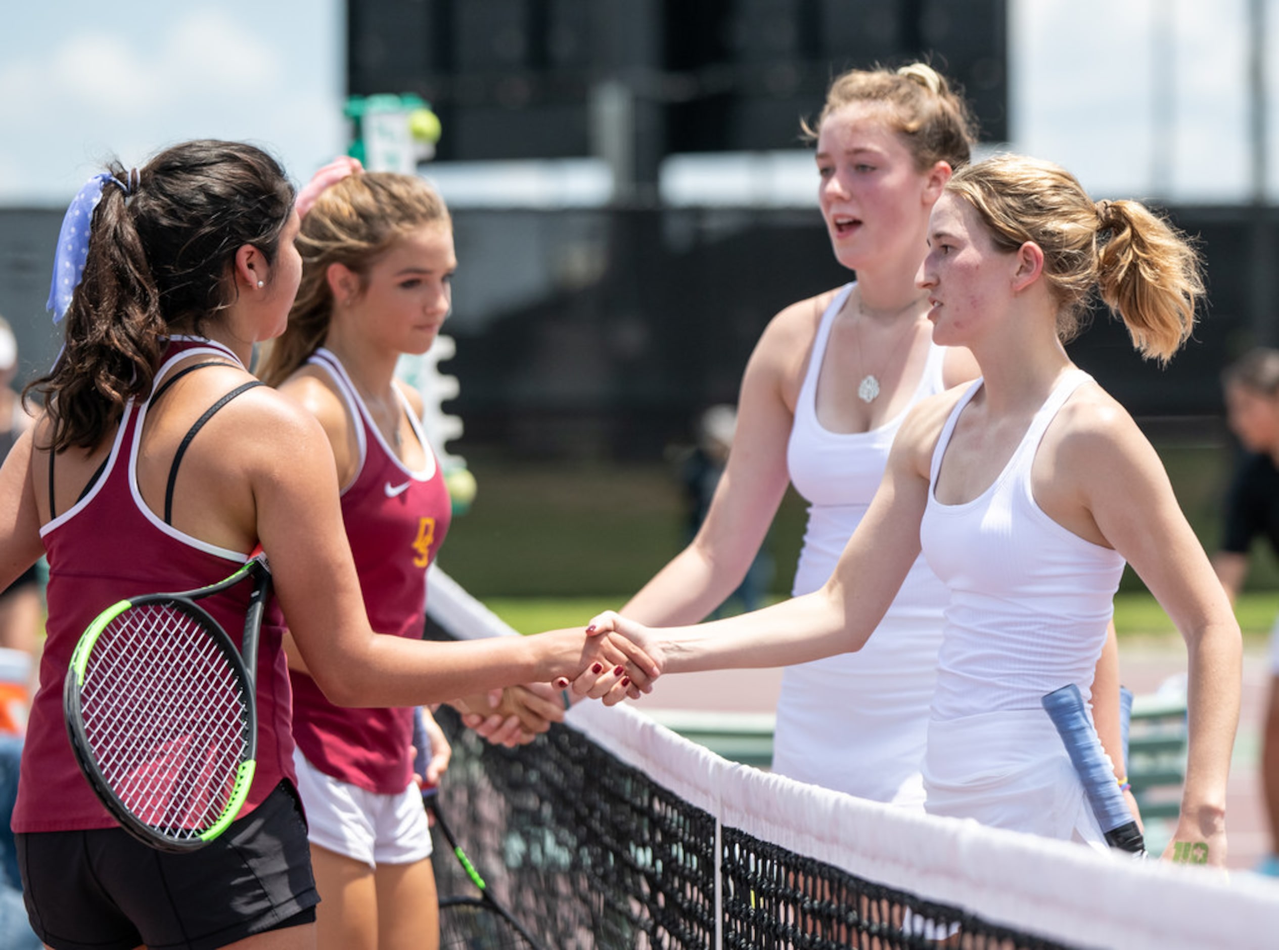 Grapevine's Madison Plowman and Reilly Cleff shake hands with Dripping Springs's Karley...