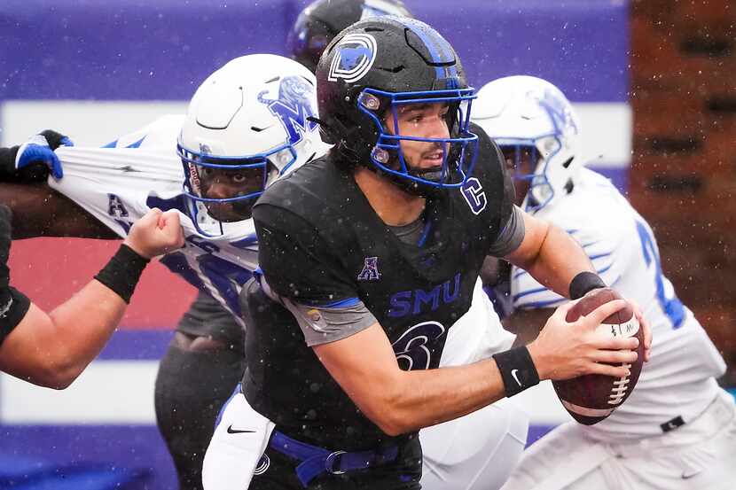 SMU quarterback Tanner Mordecai (8) scrambles from his own end zone to avoid the Memphis...