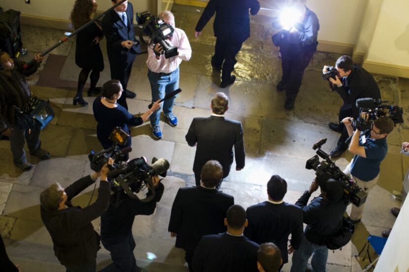 A crowd of news reporters followed House Speaker John Boehner on Thursday as he left his...