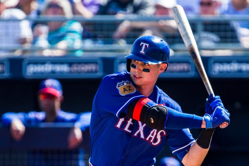 Texas Rangers third baseman Drew Robinson (68) bats during the third inning of a spring...