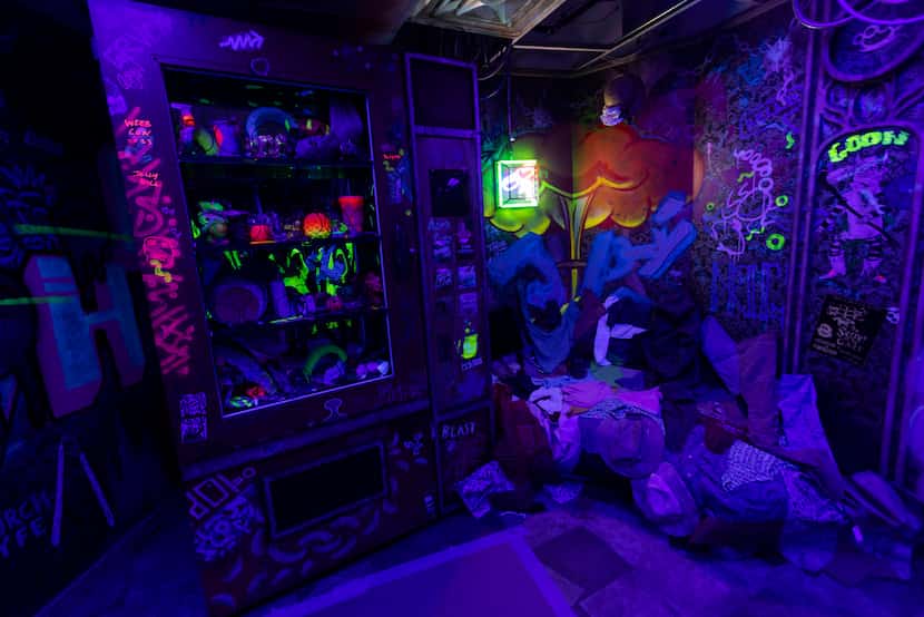 An arcade-inspired room glows under black lights at Meow Wolf Grapevine. 
