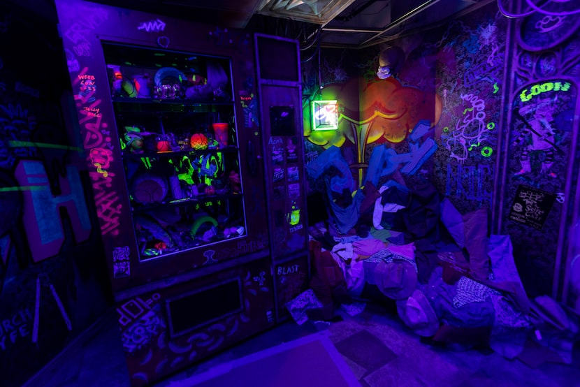 An arcade-inspired room glows under black lights at Meow Wolf Grapevine. 