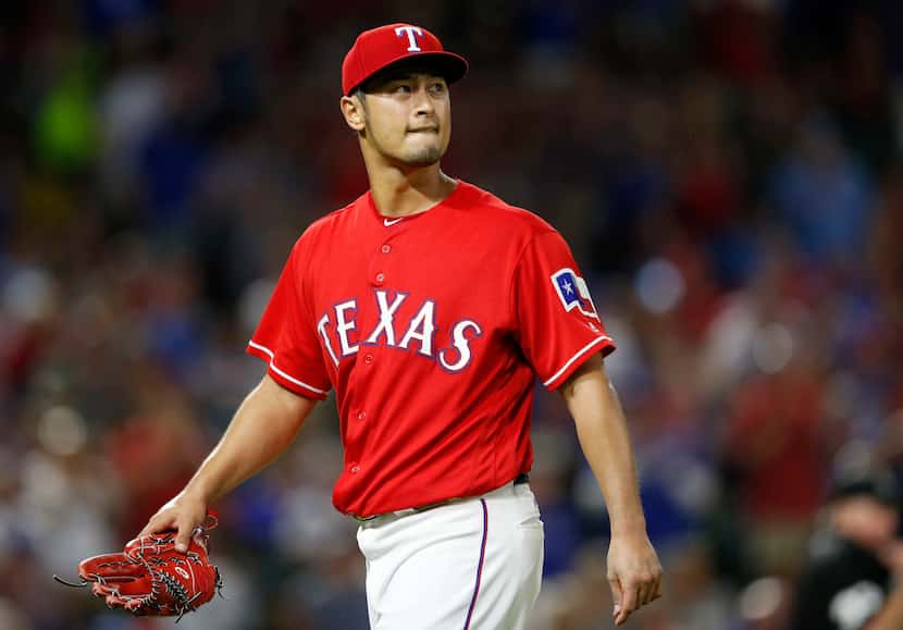 Texas Rangers starting pitcher Yu Darvish (11) exits the field in the seventh inning of play...