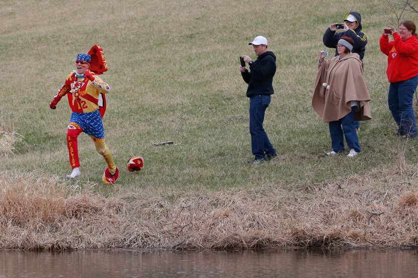 Kansas City Chiefs fan Ty Rowton, known as XFactor, is videoed by friends as he takes a...