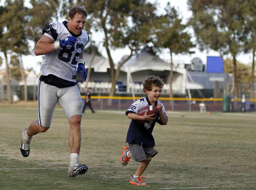 Jason Witten plays football with his son, Cooper, after an afternoon practice at Dallas...