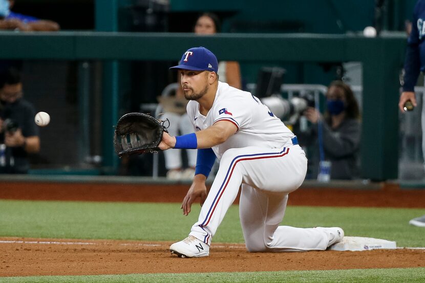 Texas Rangers first baseman Nathaniel Lowe (30) reaches to record an out during the fourth...