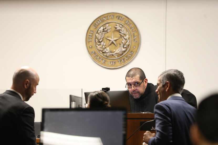 Attorneys speak with Judge Juan Renteria on June 17, 2022, in his courtroom at the George L....