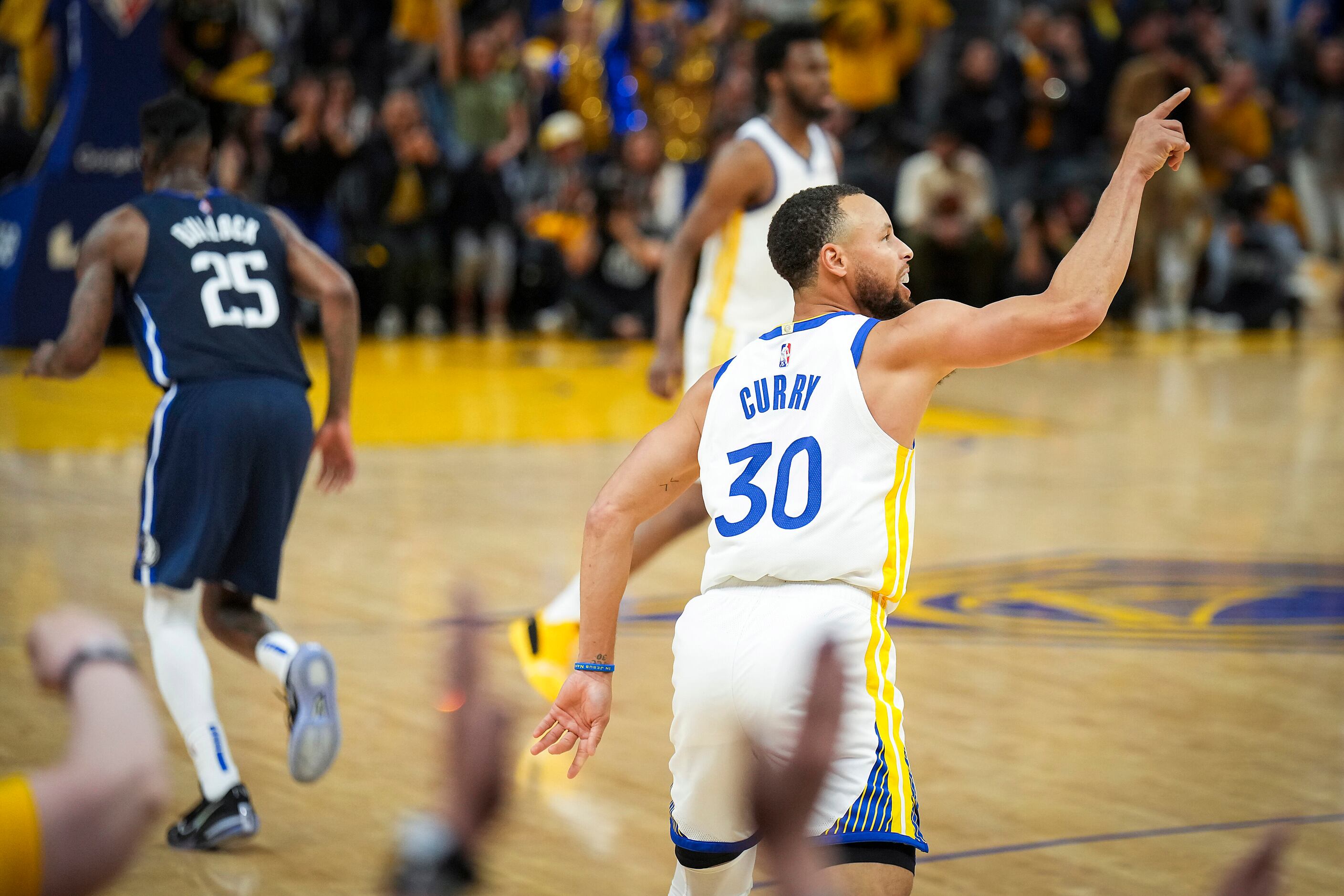 Golden State Warriors guard Stephen Curry (30) celebrates a basket as Dallas Mavericks...