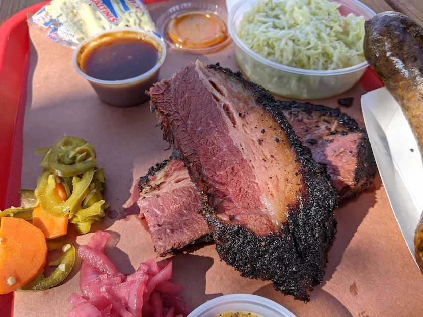 Cattleack Barbeque's pastrami-spiced brisket, plated up alongside pickled veggies, coleslaw...