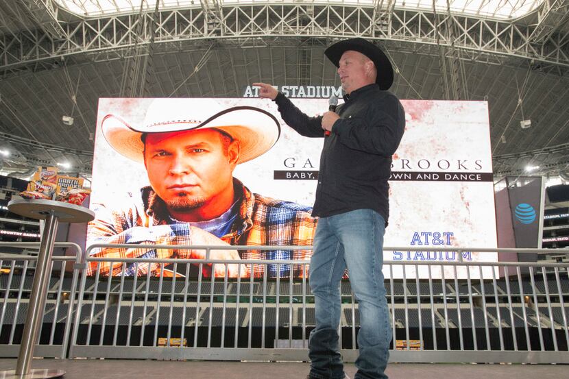 Garth Brooks talks to the media during a Thursday morning press conference at AT&T Stadium...