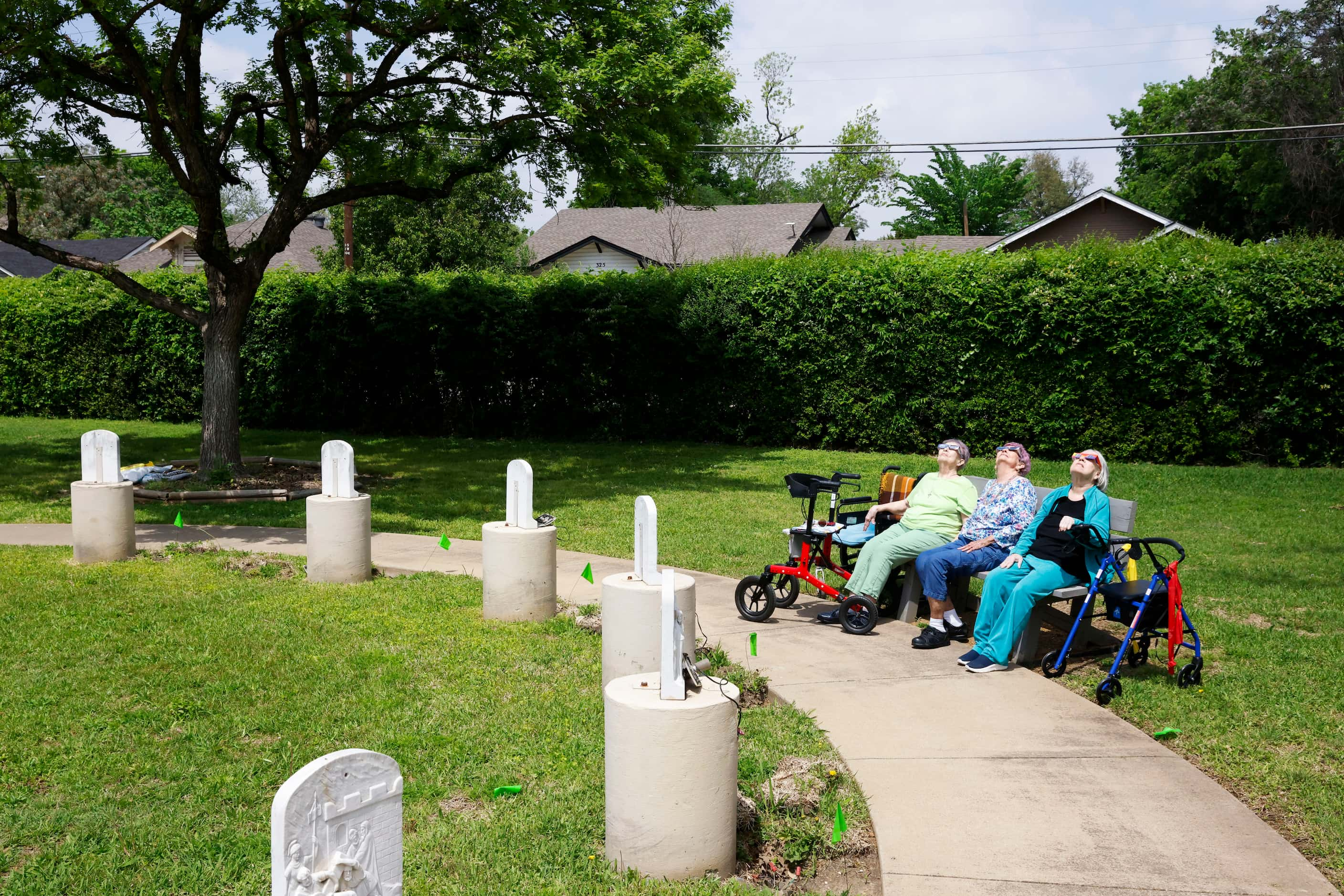 From left, Judy Green, Elizabeth Hobbs, and Patricia Head, look up as they enjoy the view of...