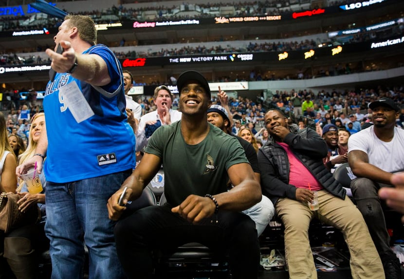 Dallas Cowboys free safety Byron Jones, center, stands up as fans shout "Romo, Romo" during...