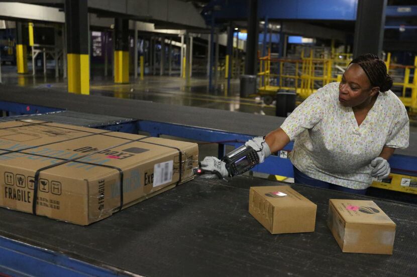 Special scanners that can be worn on the wrist help employees track packages at the FedEx...