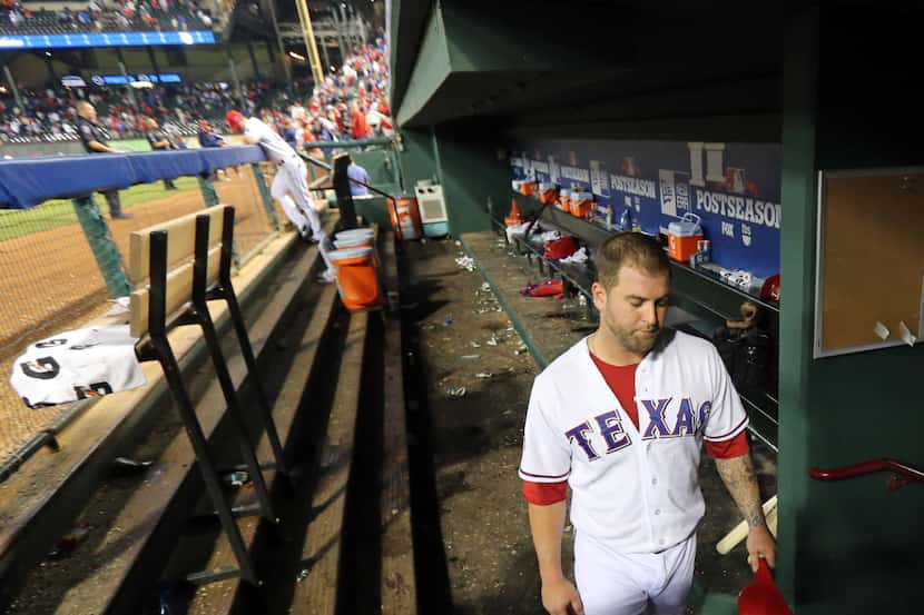 Texas catcher Mike Napoli leaves the dugout long after the rest of his teammates at the end...