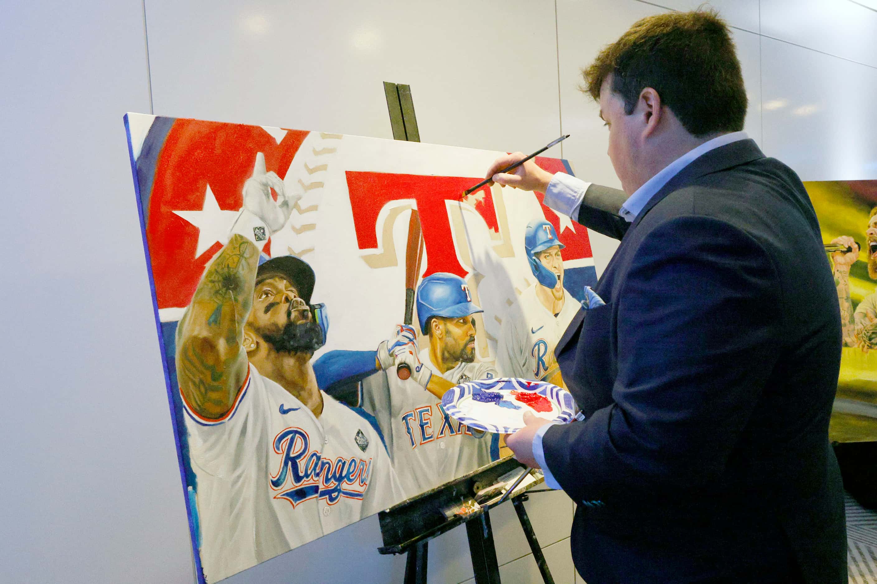 Artist Chuck Braud of Baton Rouge, La. creates a Texas Rangers painting during the Faith...