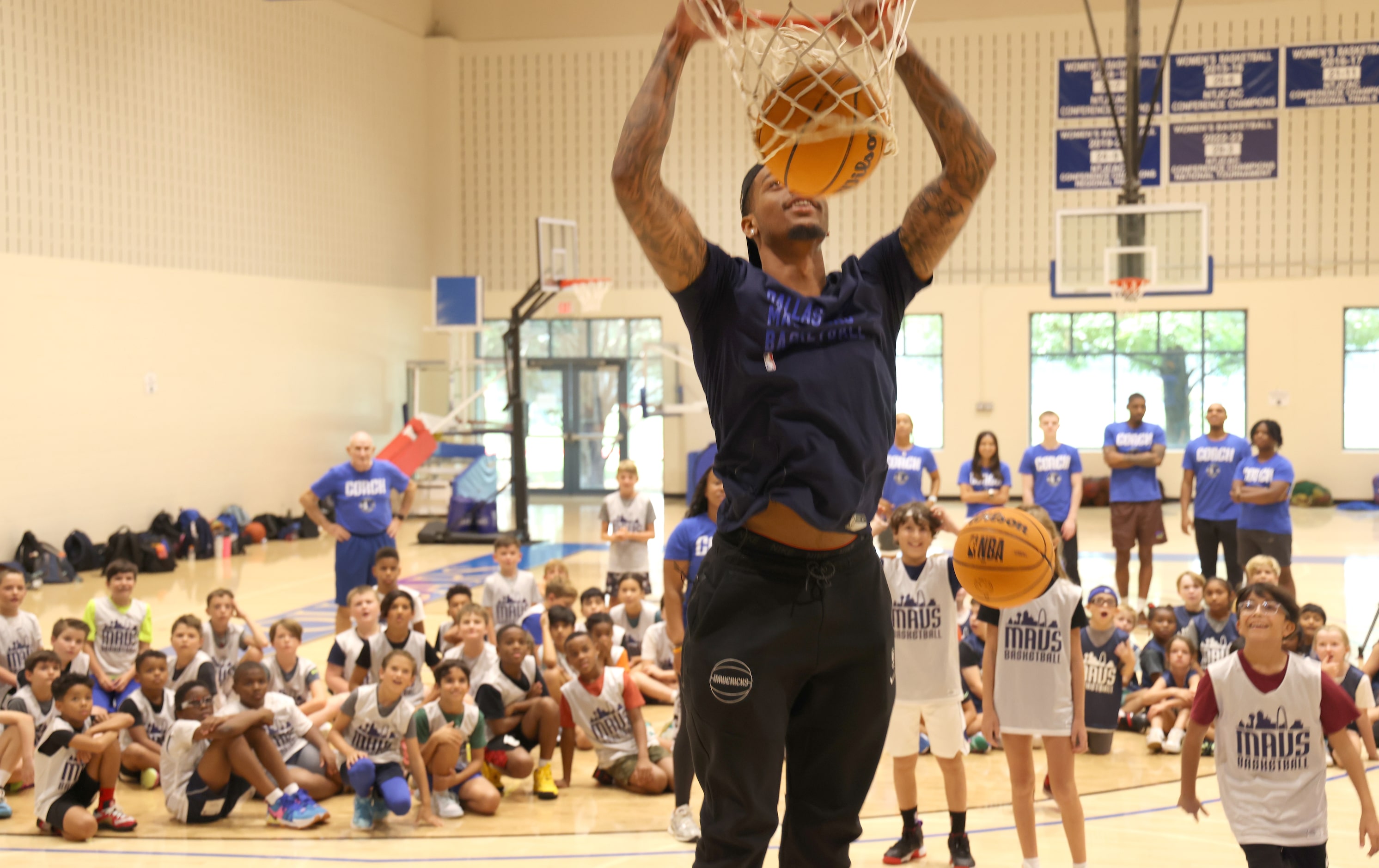 Dallas Mavericks forward and center PJ Washington finishes a dunk to the delight of Hoop...