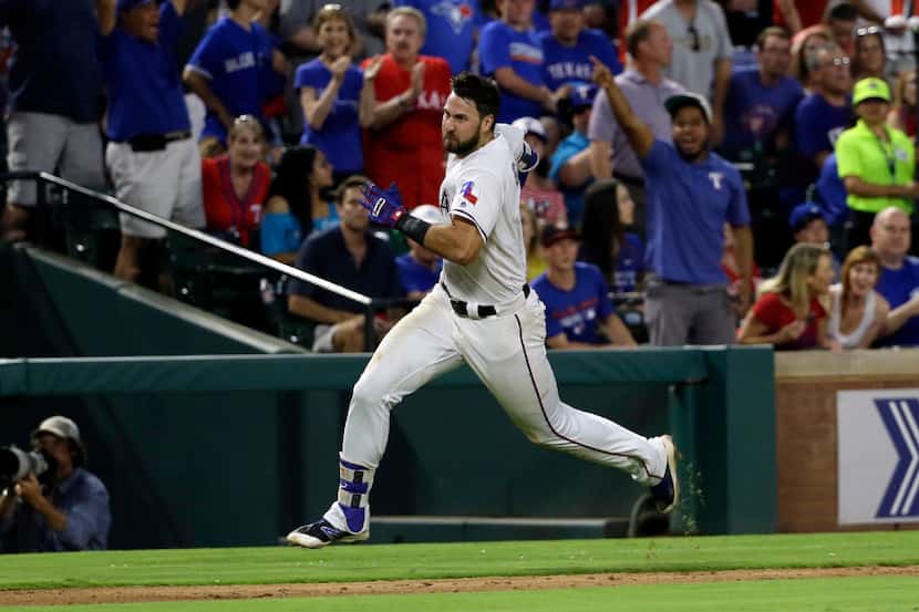 Texas Rangers' Joey Gallo rounds third on his way home after hitting a inside-the-park home...