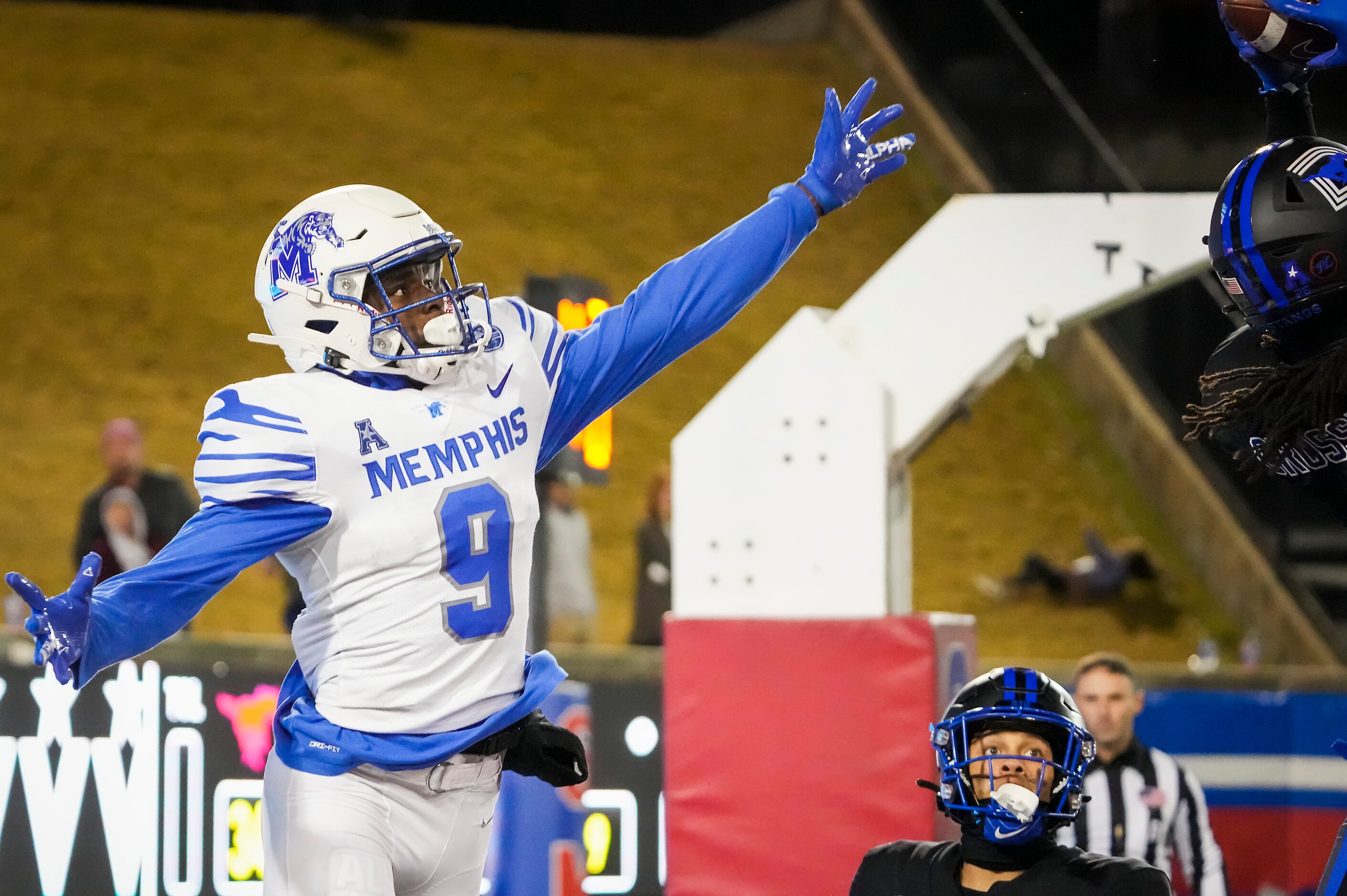 Memphis wide receiver Gabriel Rogers (9) looks back as SMU safety Brandon Crossley (1)...