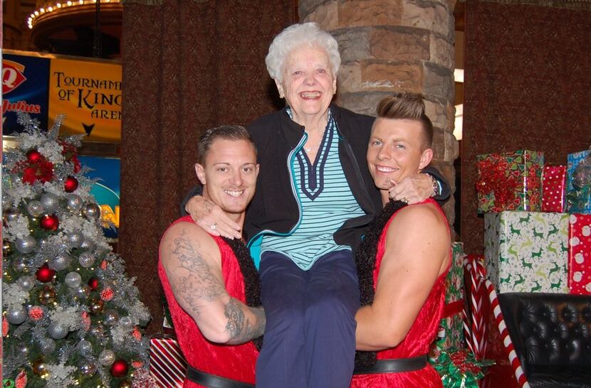 Two dancers from the "Thunder From Down Under" show in Las Vegas held Barbara Cannizzaro in...