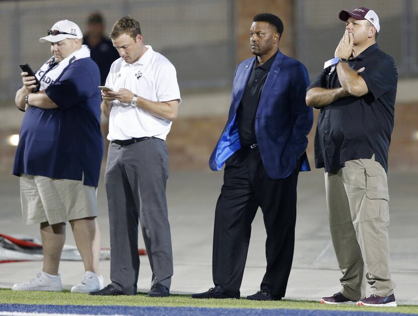 Texas A&M football head coach Kevin Sumlin watches a high school football game between Allen...