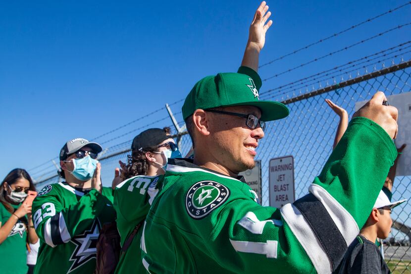 Simon Bench (right), from Fort Worth, cheers with other fans as the Dallas Stars land at...