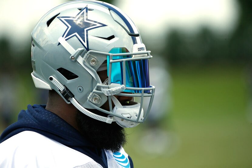 Dallas Cowboys running back Ezekiel Elliott (21) looks on during an organized team activity...