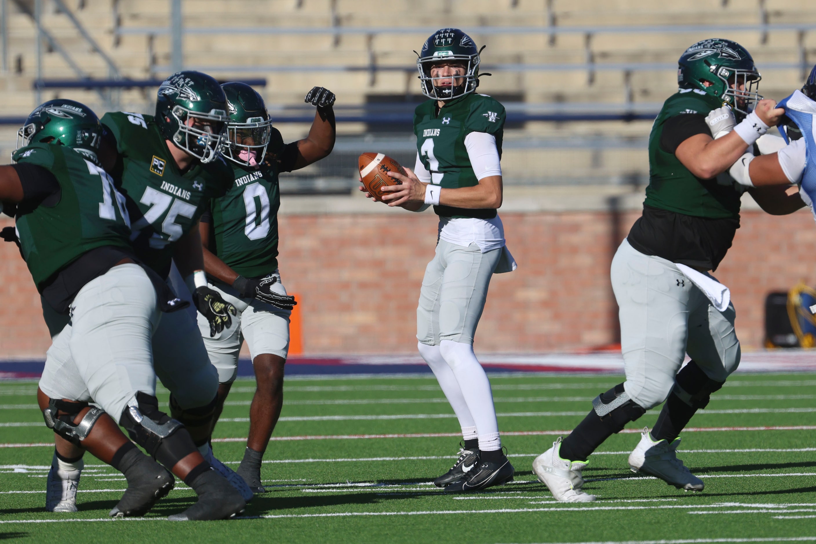 Waxahachie High’s QB Jerry Meyer III looks to throw the ball against North Forney High...