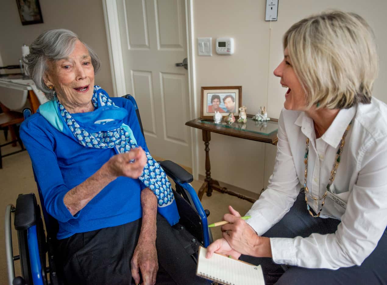 Judith Holbrook, left, a resident at Belmont Village in Dallas, Texas, talks with Tina Lott...