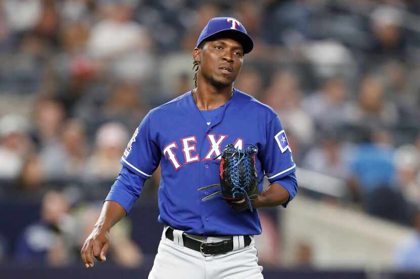 Texas Rangers' relief pitcher Rafael Montero reacts on the mound after allowing a two-run,...