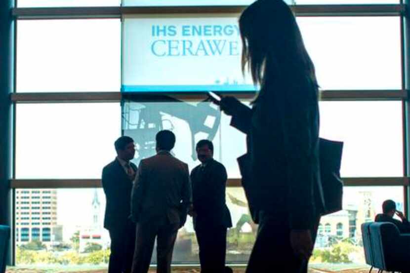 
A delegate checks her phone at the IHS CERAWeek energy conference in Houston.

