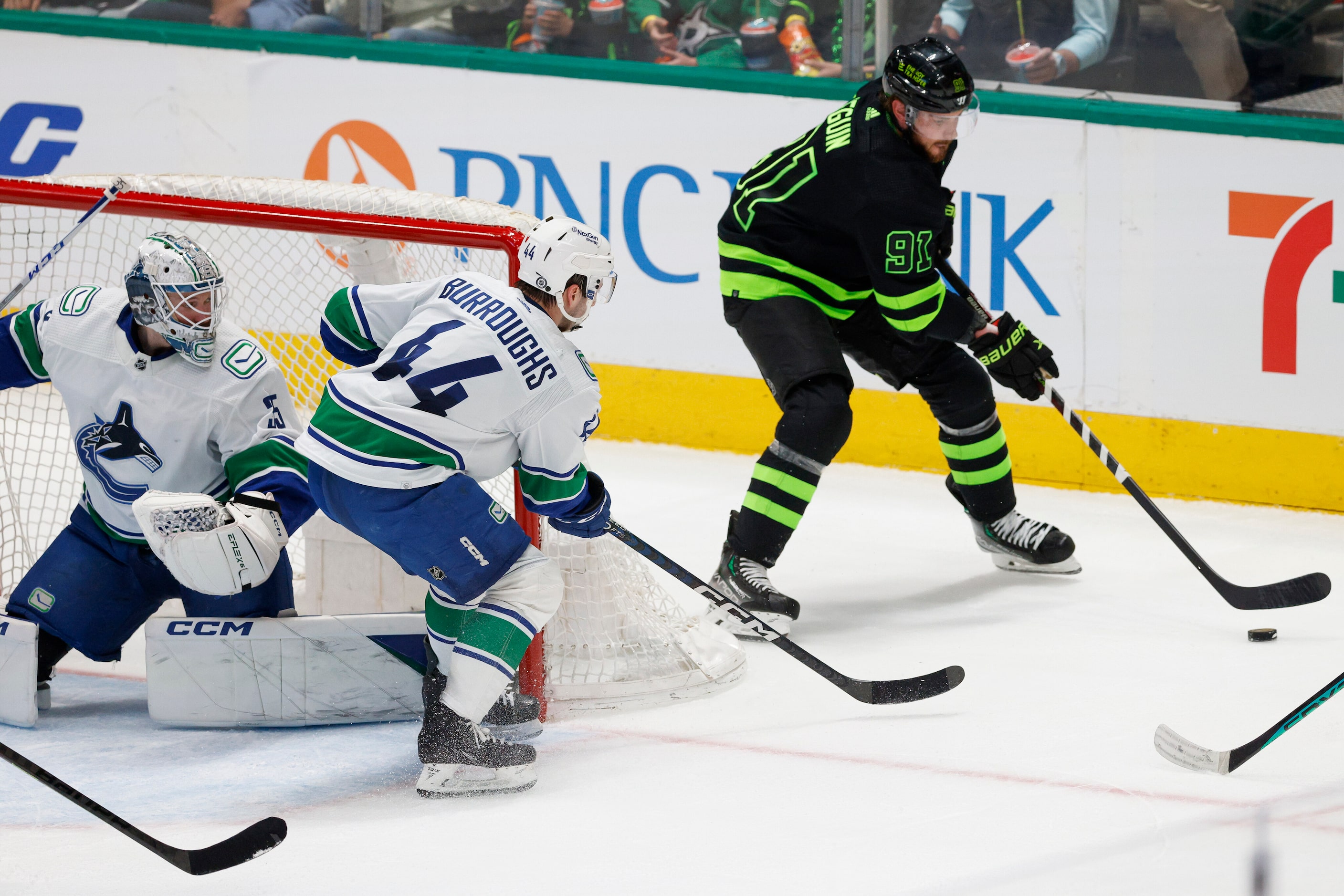 Dallas Stars center Tyler Seguin (91) skates behind the net alongside center Max Domi (18)...