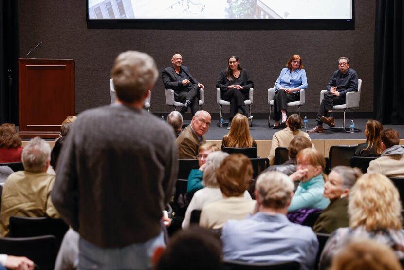 Bart Wade, left, asks questions of the panelists during a community event panel discussion...
