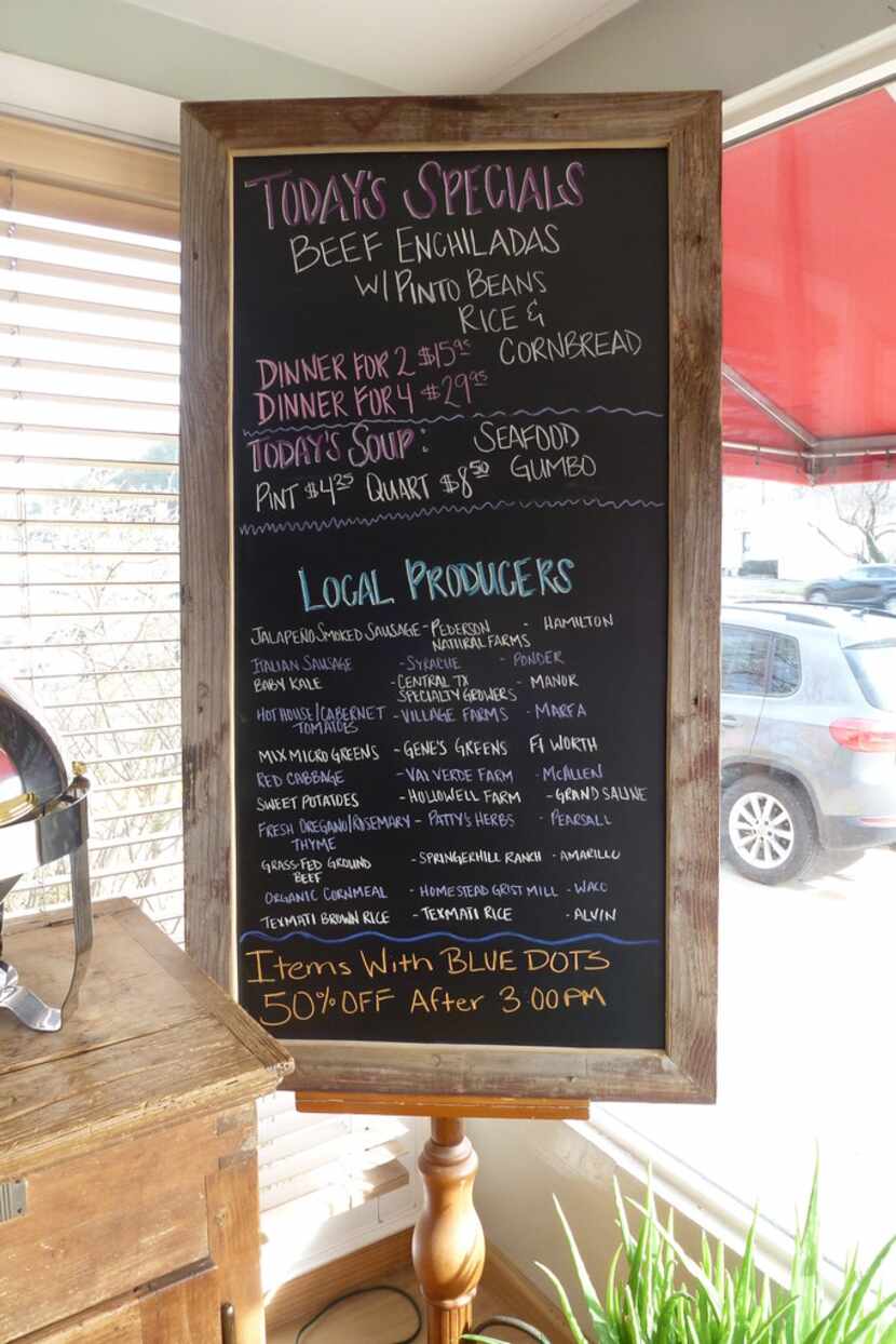 At Celebration Market, as in the restaurant, a blackboard touts local sources of meats,...