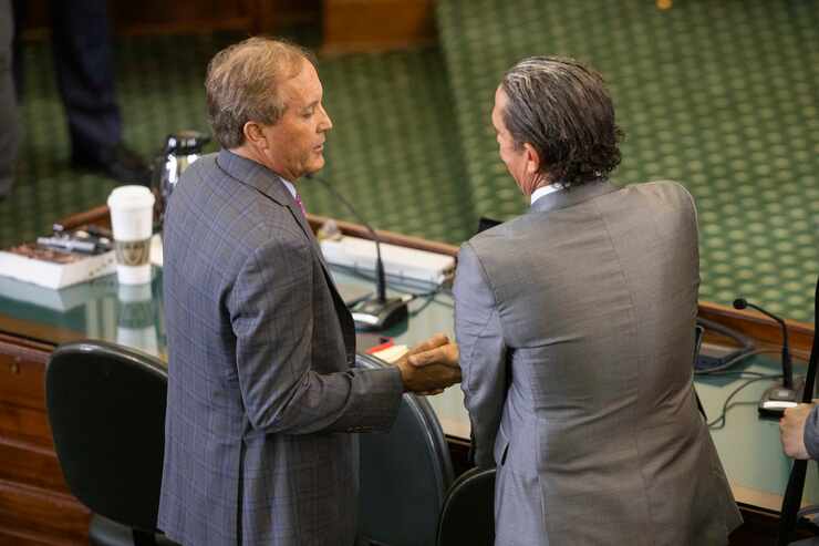 (From left) Texas Attorney General Ken Paxton shakes attorney Tony Buzbee’s hand after the...