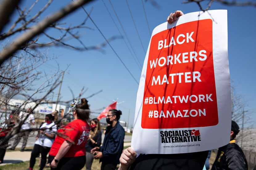 Demonstrators rally near the Amazon fulfillment center in Dallas on March 20, 2021 to...