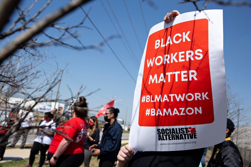 Demonstrators rally near the Amazon fulfillment center in Dallas on March 20, 2021 to...