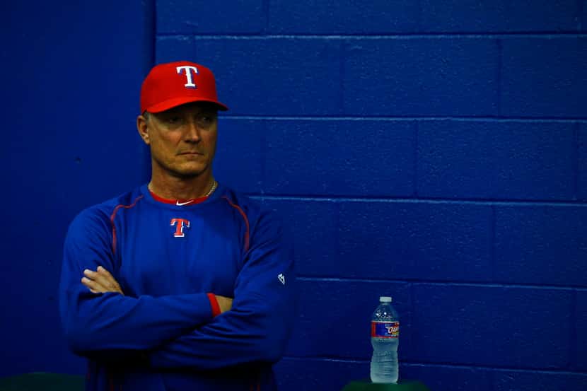 Jeff Banister, manager of the Texas Rangers, watches a press conference as Josh Hamilton and...