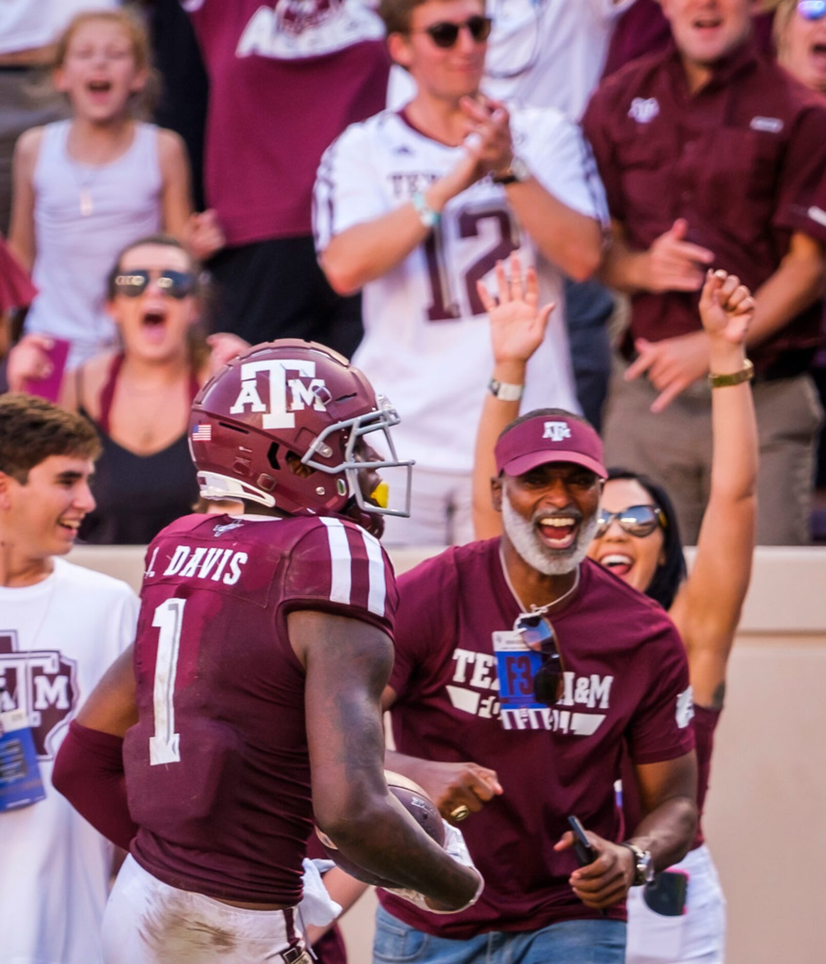 Fans cheer as Texas A&M wide receiver Quartney Davis (1) scores on a 27-yard touchdown...