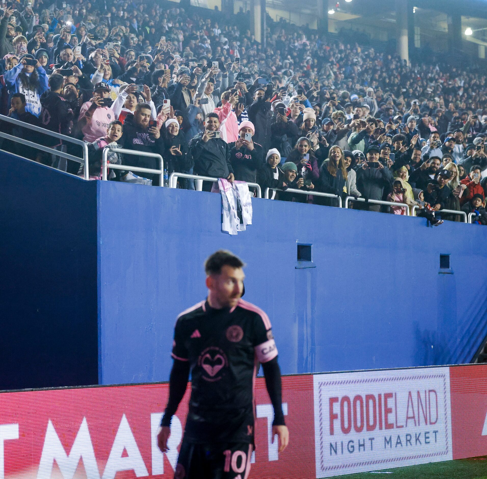 Fans cheer for Inter Miami forward Lionel Messi as he prepares to take a corner kick against...