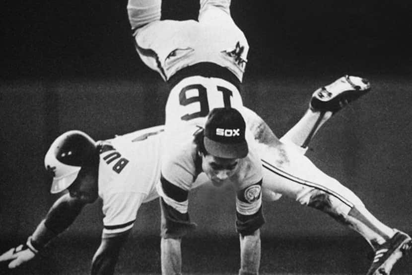  October 5, 1983-- Chicago second baseman Julio Cruz is upended by Baltimore base runner Al...