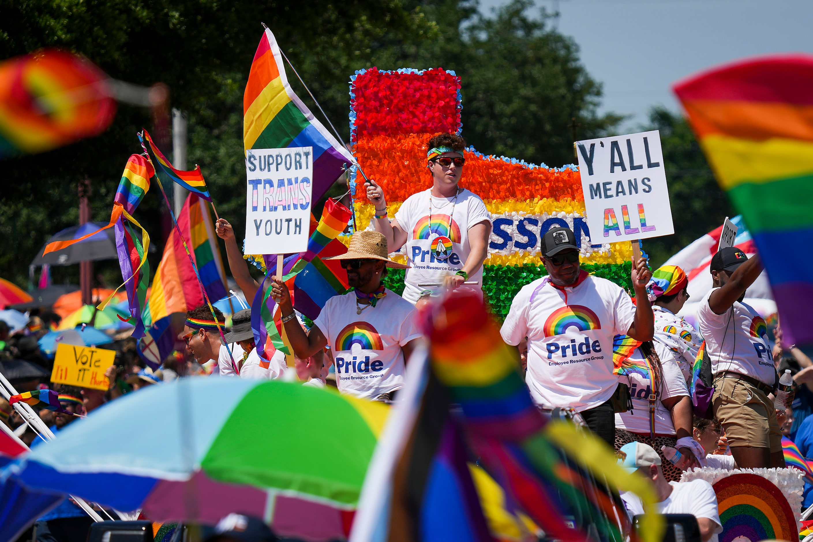 Participants wave from the McKesson float during the annual Alan Ross Texas Freedom Parade...